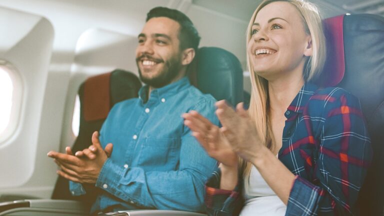 couple clapping on plane