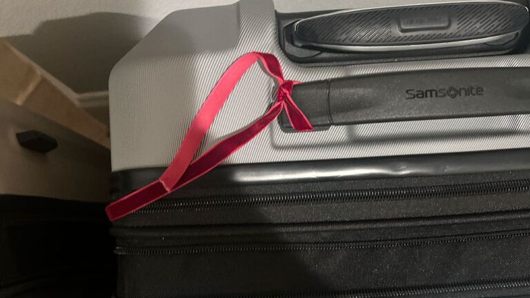 red ribbon on luggage